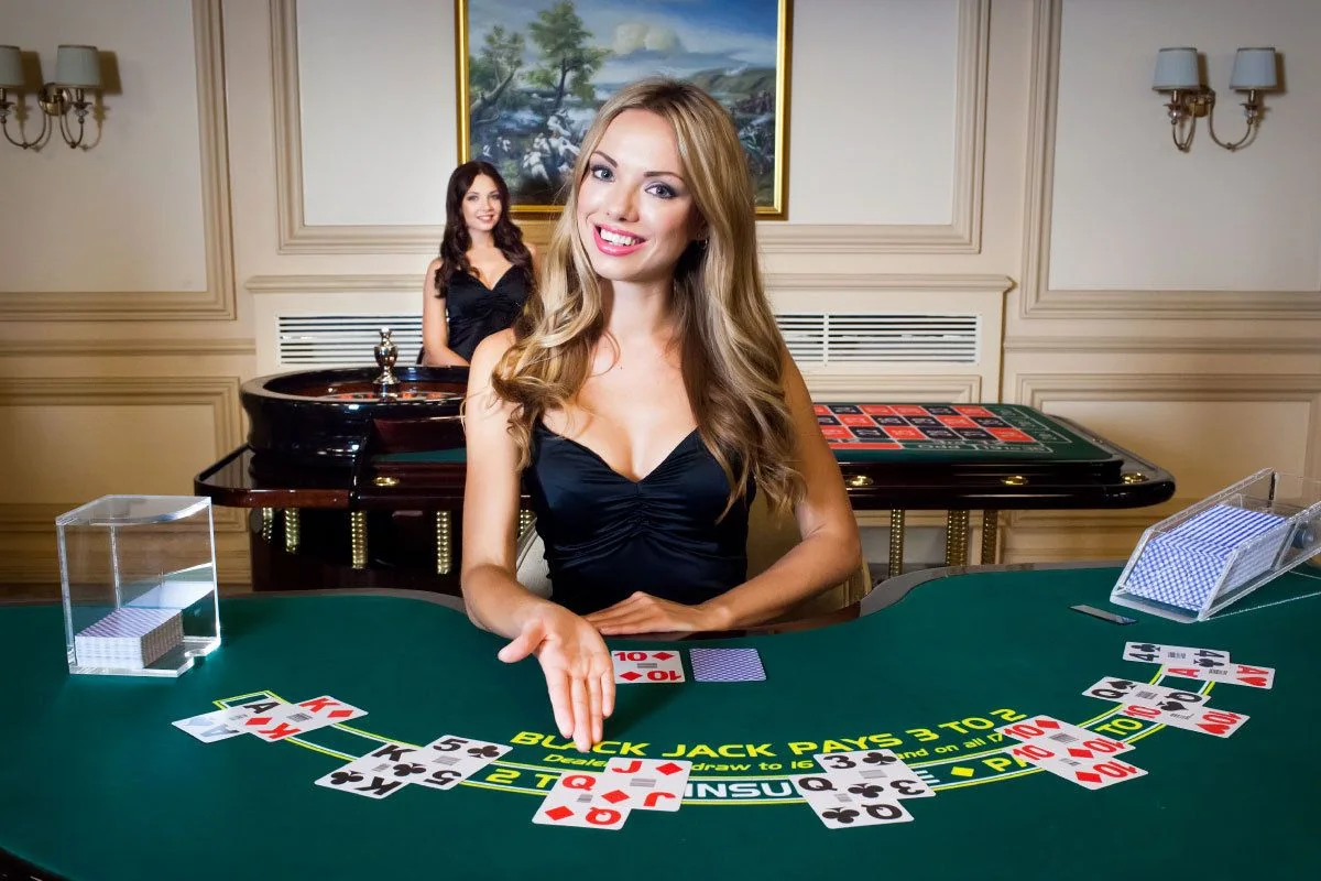 Suasana meja kasino live WIN33 dengan dealer dan layar permainan